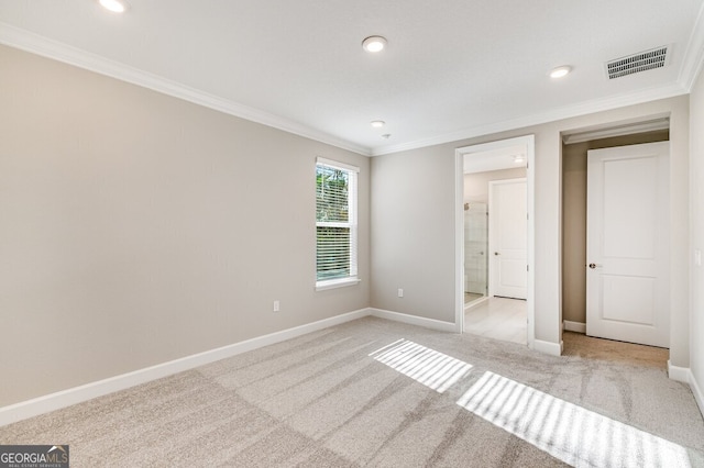 unfurnished bedroom featuring crown molding and light carpet