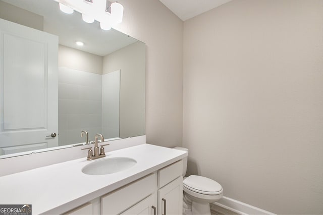 bathroom featuring toilet and vanity