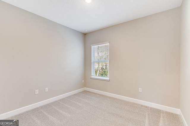 unfurnished room featuring light colored carpet