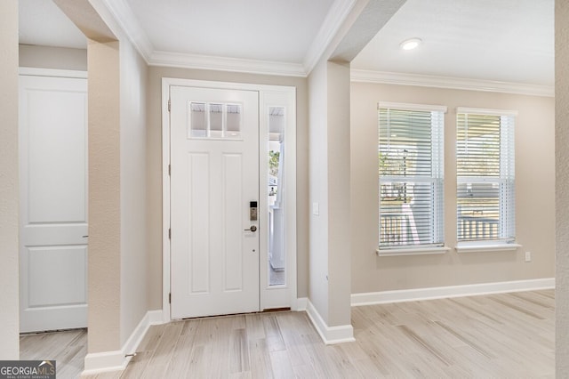 entryway featuring light hardwood / wood-style flooring and crown molding