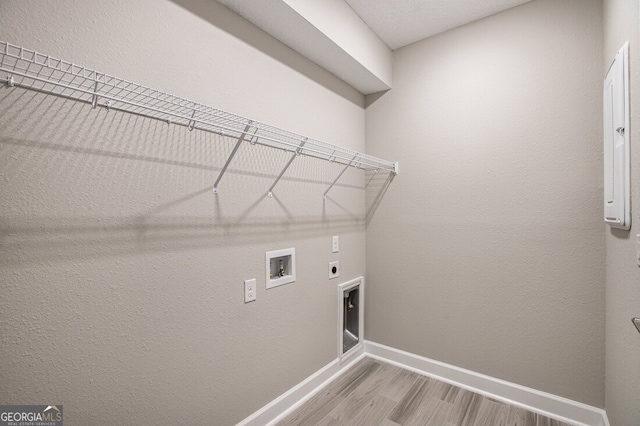 laundry area featuring hardwood / wood-style flooring, washer hookup, and hookup for an electric dryer