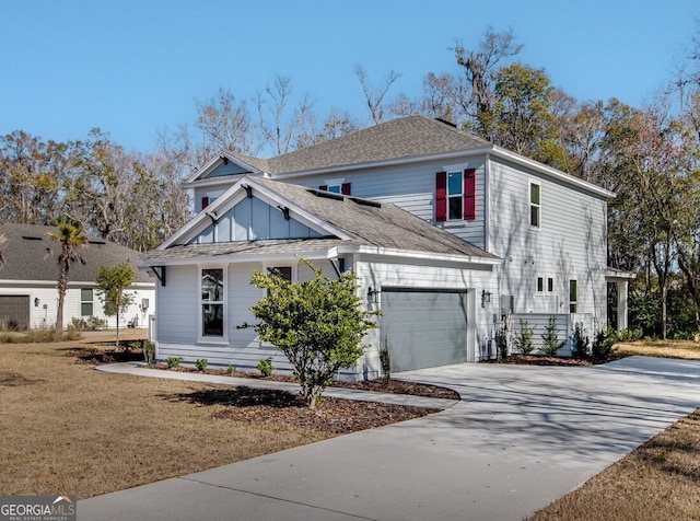 view of front of house featuring a garage and a front lawn