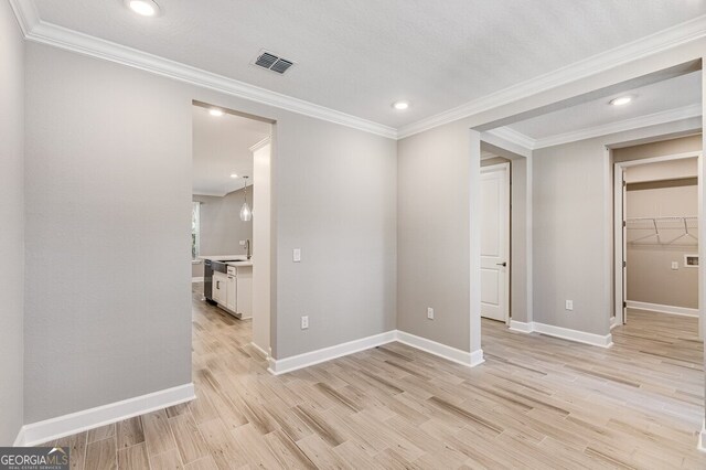 kitchen featuring pendant lighting, white cabinets, and sink