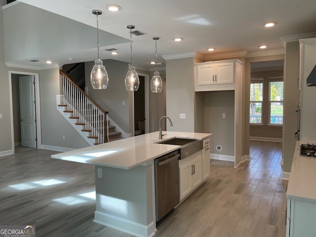 kitchen featuring dishwasher, white cabinets, an island with sink, and sink