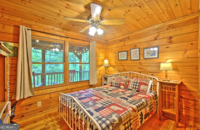 bedroom featuring hardwood / wood-style floors, ceiling fan, and wood ceiling