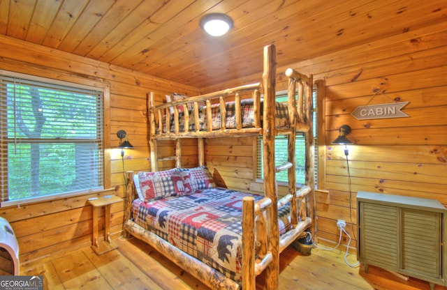 bedroom featuring wooden ceiling and light hardwood / wood-style floors