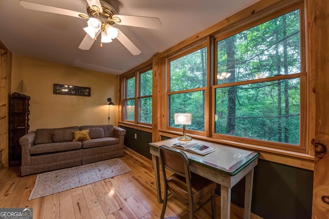 interior space with ceiling fan