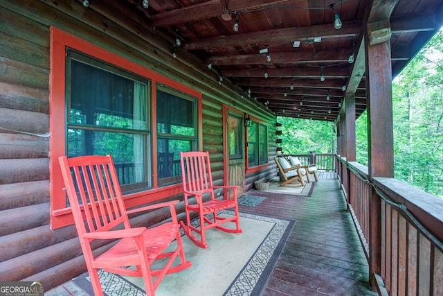 wooden terrace featuring covered porch