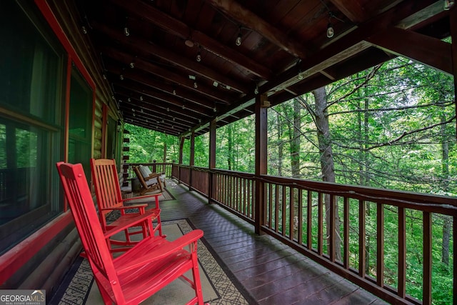 wooden terrace featuring covered porch