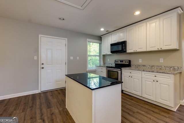 2911 Glenwood Ave SE, Atlanta, GA 30317 - kitchen with white cabinets, a center island, electric range, and dark wood-type flooring