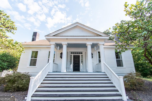 1651 Mergendollar Rd, Good Hope, GA 30641 - greek revival inspired property with a porch, stairs, and a chimney
