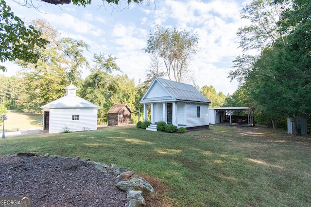 1651 Mergendollar Rd, Good Hope, GA 30641 - view of yard featuring a carport, a shed, and an outdoor structure