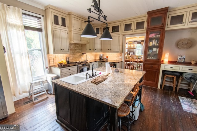 1651 Mergendollar Rd, Good Hope, GA 30641 - kitchen with dark wood-type flooring, cream cabinets, plenty of natural light, and an island with sink
