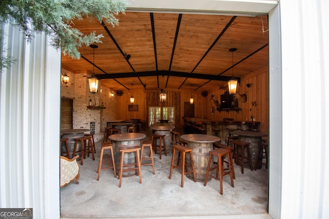 1651 Mergendollar Rd, Good Hope, GA 30641 - dining room featuring concrete flooring, a dry bar, wooden ceiling, and lofted ceiling