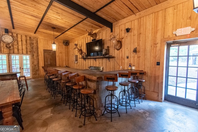 1651 Mergendollar Rd, Good Hope, GA 30641 - bar featuring unfinished concrete flooring, a community bar, and lofted ceiling with beams