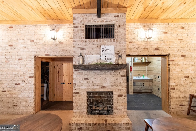 1651 Mergendollar Rd, Good Hope, GA 30641 - bathroom with a sink, a brick fireplace, wooden ceiling, and brick wall