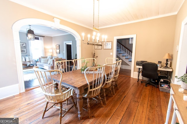 1651 Mergendollar Rd, Good Hope, GA 30641 - dining space with a chandelier, arched walkways, hardwood / wood-style floors, and crown molding