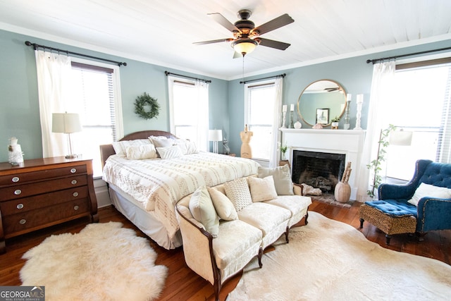 1651 Mergendollar Rd, Good Hope, GA 30641 - bedroom with ornamental molding, multiple windows, wood finished floors, and a fireplace