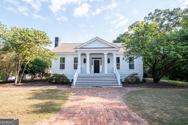 1651 Mergendollar Rd, Good Hope, GA 30641 - neoclassical home with roof with shingles, a chimney, and a front yard