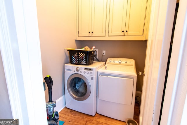 1651 Mergendollar Rd, Good Hope, GA 30641 - washroom featuring light wood-type flooring, separate washer and dryer, and cabinet space