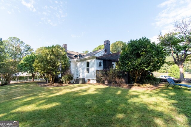 1651 Mergendollar Rd, Good Hope, GA 30641 - rear view of house featuring a chimney and a lawn