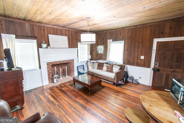 1651 Mergendollar Rd, Good Hope, GA 30641 - living area with visible vents, wood ceiling, a fireplace with flush hearth, wood finished floors, and wood walls