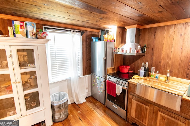 1651 Mergendollar Rd, Good Hope, GA 30641 - kitchen with exhaust hood, appliances with stainless steel finishes, wood ceiling, brown cabinets, and light wood finished floors