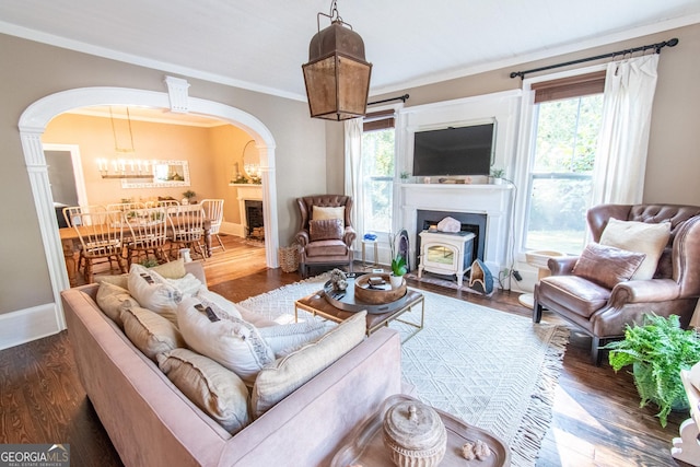 1651 Mergendollar Rd, Good Hope, GA 30641 - living room with arched walkways, baseboards, crown molding, and wood finished floors