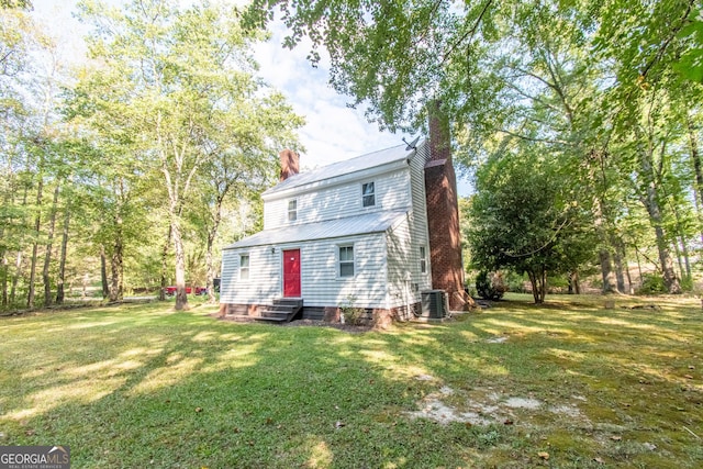1651 Mergendollar Rd, Good Hope, GA 30641 - back of property with entry steps, a chimney, a yard, and central AC