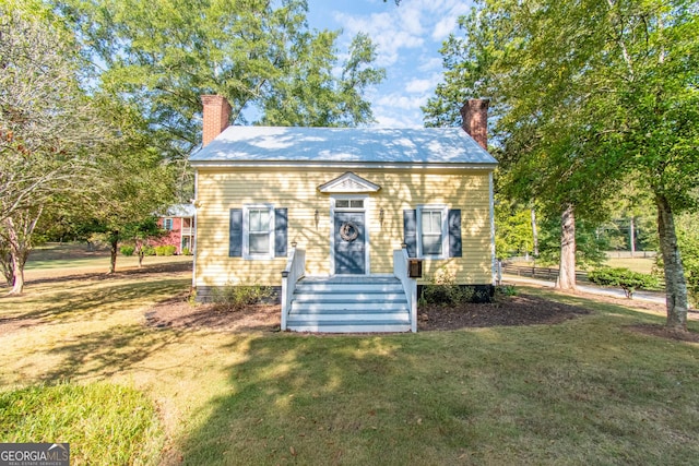 1651 Mergendollar Rd, Good Hope, GA 30641 - view of front of property featuring a chimney, metal roof, and a front yard