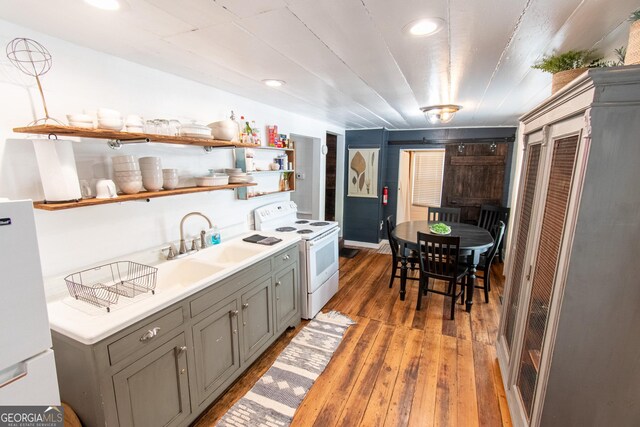 1651 Mergendollar Rd, Good Hope, GA 30641 - kitchen featuring gray cabinets, white appliances, open shelves, wood-type flooring, and a sink