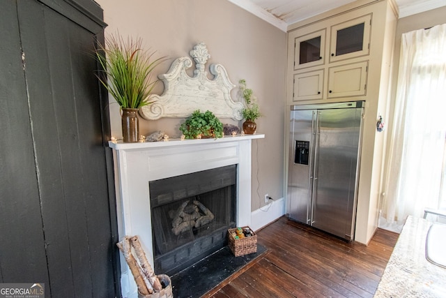 1651 Mergendollar Rd, Good Hope, GA 30641 - kitchen featuring a fireplace with flush hearth, crown molding, dark wood-style flooring, and stainless steel fridge