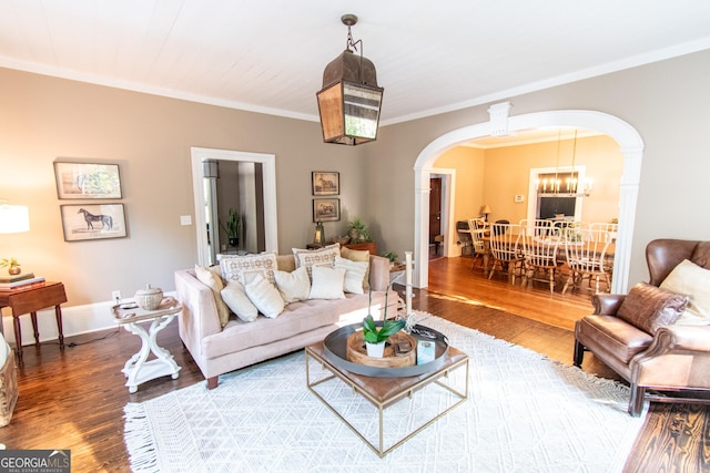 1651 Mergendollar Rd, Good Hope, GA 30641 - living area featuring a chandelier, arched walkways, wood finished floors, and ornamental molding