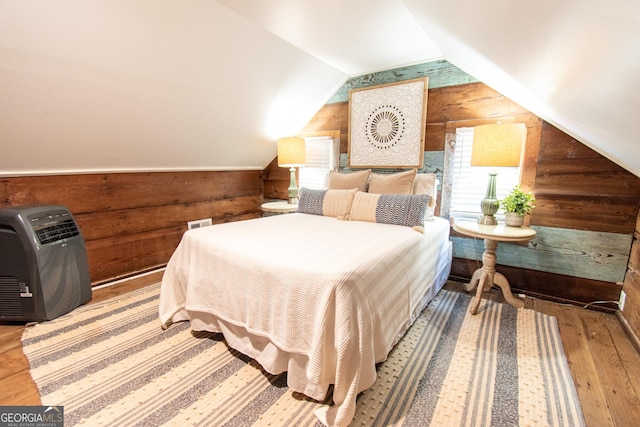 1651 Mergendollar Rd, Good Hope, GA 30641 - bedroom featuring hardwood / wood-style floors, wooden walls, lofted ceiling, and heating unit
