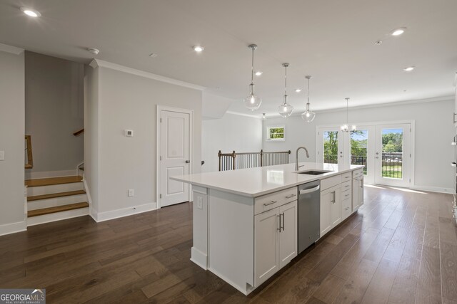 kitchen featuring a center island with sink, stainless steel dishwasher, dark hardwood / wood-style floors, and decorative light fixtures