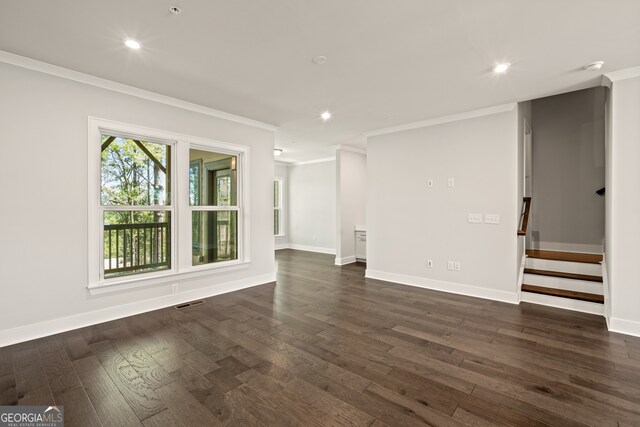 empty room featuring crown molding and dark wood-type flooring