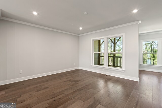 unfurnished room with ornamental molding and dark hardwood / wood-style flooring