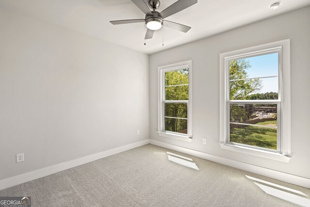 carpeted empty room with ceiling fan