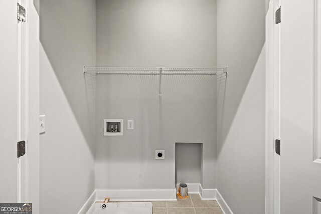 laundry area featuring hookup for a washing machine, light tile patterned floors, electric dryer hookup, and gas dryer hookup