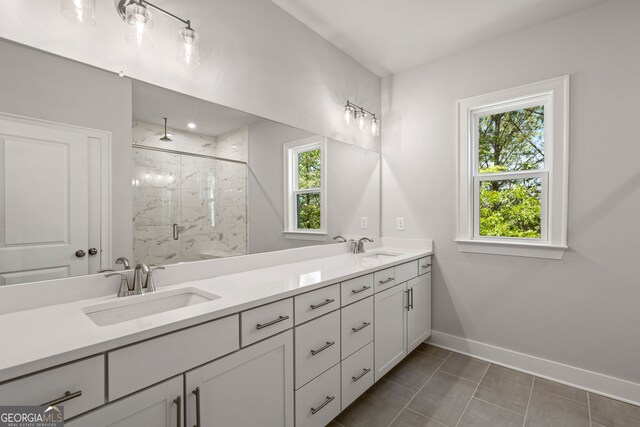 bathroom featuring walk in shower, tile patterned flooring, and vanity