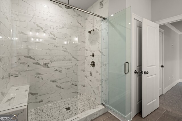 bathroom featuring tile patterned floors and an enclosed shower