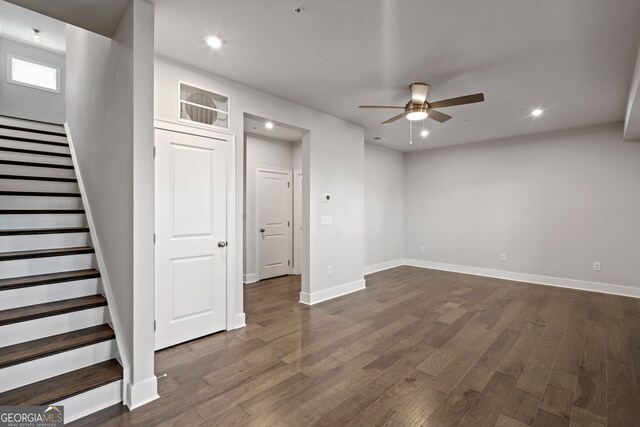 basement with ceiling fan and dark wood-type flooring