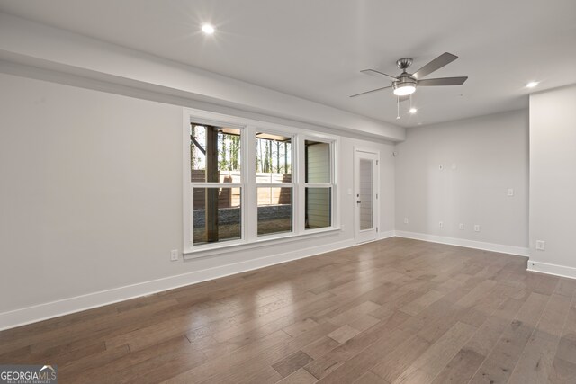 unfurnished room featuring ceiling fan and hardwood / wood-style flooring