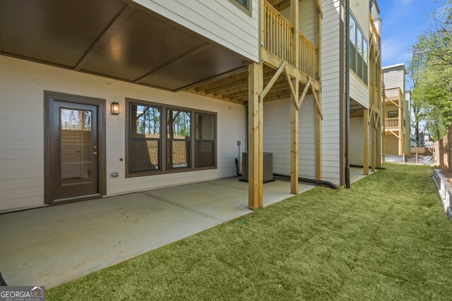 exterior space with a patio, cooling unit, and a lawn