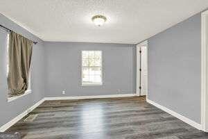 unfurnished room featuring dark wood-type flooring