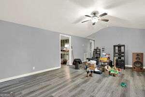 unfurnished living room with lofted ceiling, ceiling fan, and hardwood / wood-style flooring