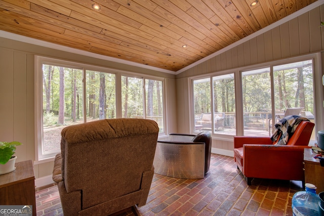 interior space with wooden ceiling, vaulted ceiling, and plenty of natural light