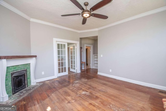 unfurnished living room featuring ceiling fan, ornamental molding, wood-type flooring, french doors, and a textured ceiling