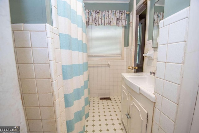 bathroom with vanity, tile walls, and a shower with shower curtain