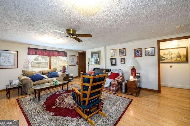 living room featuring a textured ceiling, ceiling fan, and hardwood / wood-style flooring